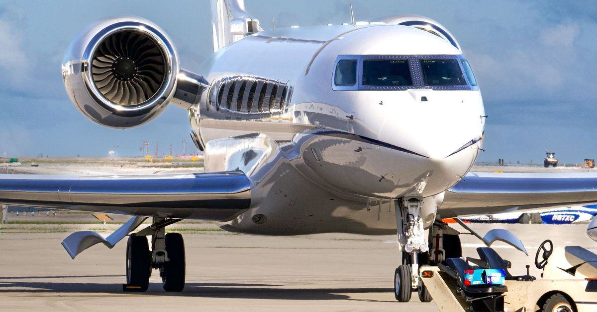 Gulfstream business jet on the apron with a tug connected, ready to be moved for AOG support