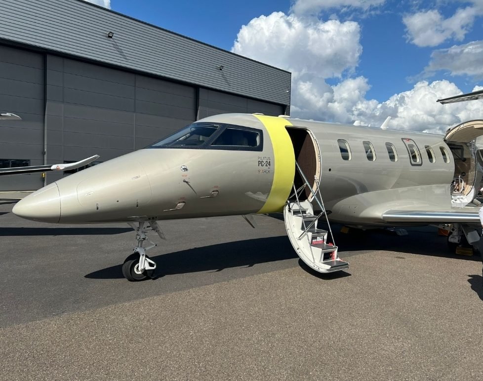 Pilatus PC-24 business jet with airstair open outside a hangar, ready for an aircraft sale viewing