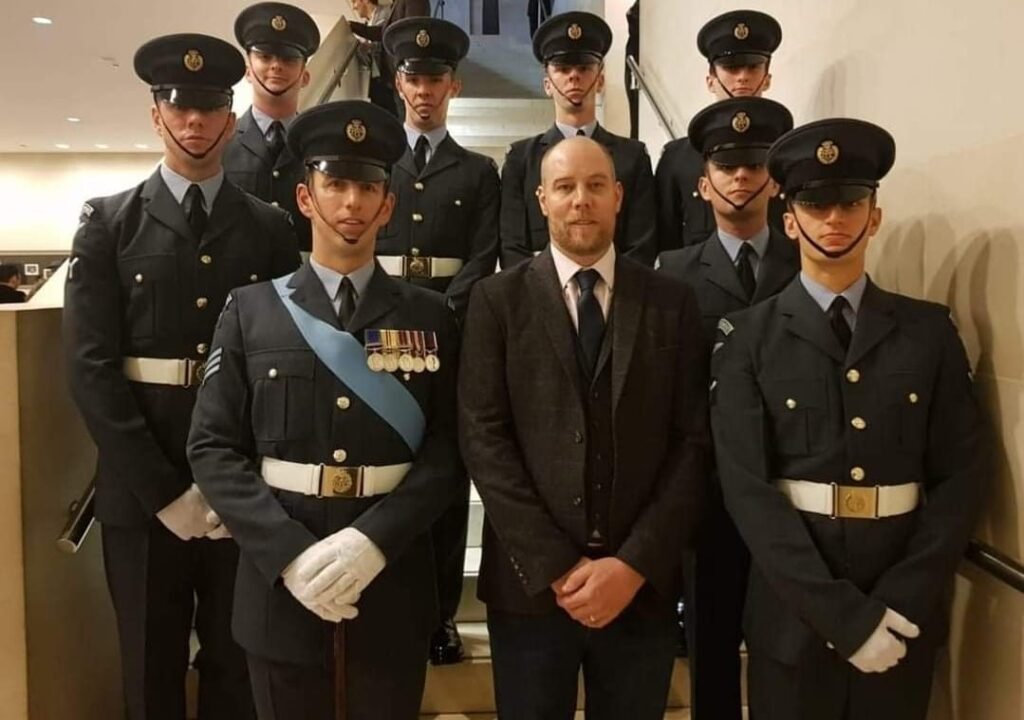 Carl Griffiths with serving members of the Royal Air Force in dress uniform